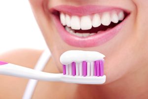 a woman brushing her teeth