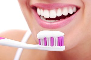 a woman brushing her teeth